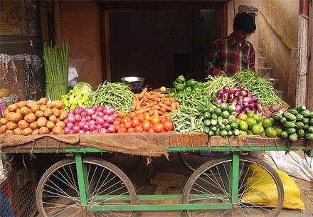 Sprzedawca warzyw z Bangalore. Na jego straganie ziemniaki, ogórki, marchew, rzodkiewka, fasola...